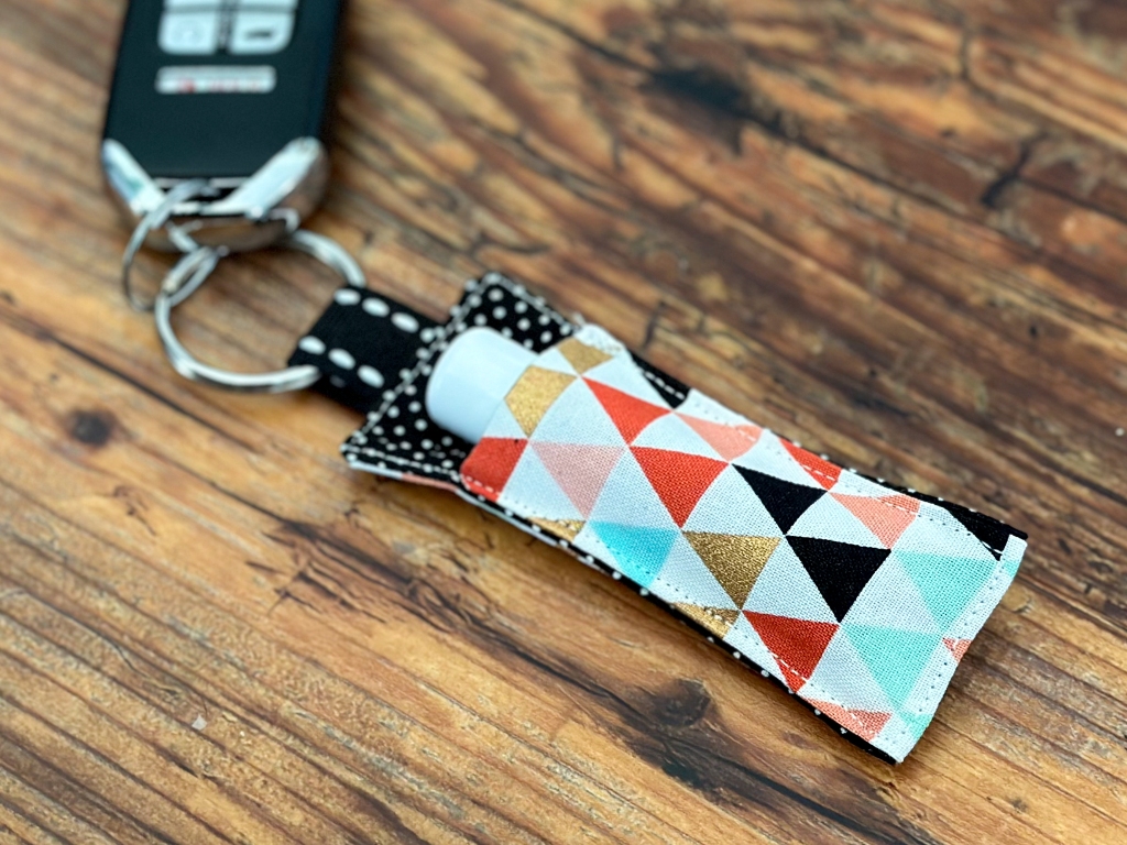 close up of a DIY fabric lip balm holder clipped to keys