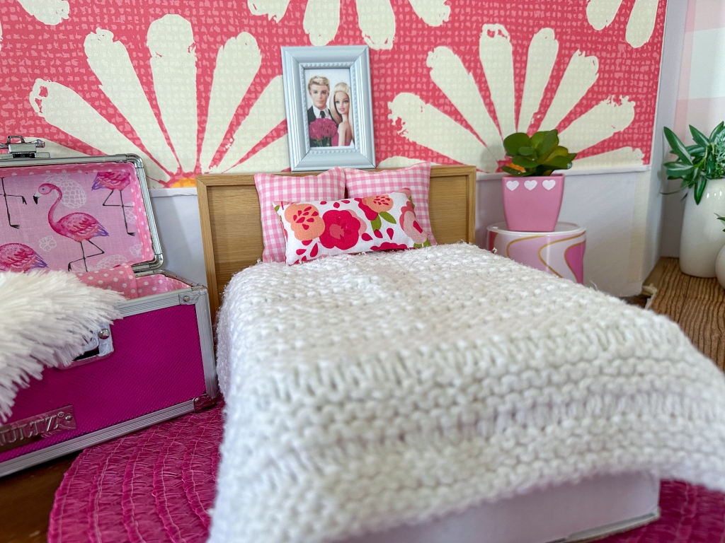 Close up of the bedroom in a modern cardboard fold-out Barbie house based on the 1962 version